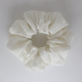 Ivory scrunchie on a light gray background