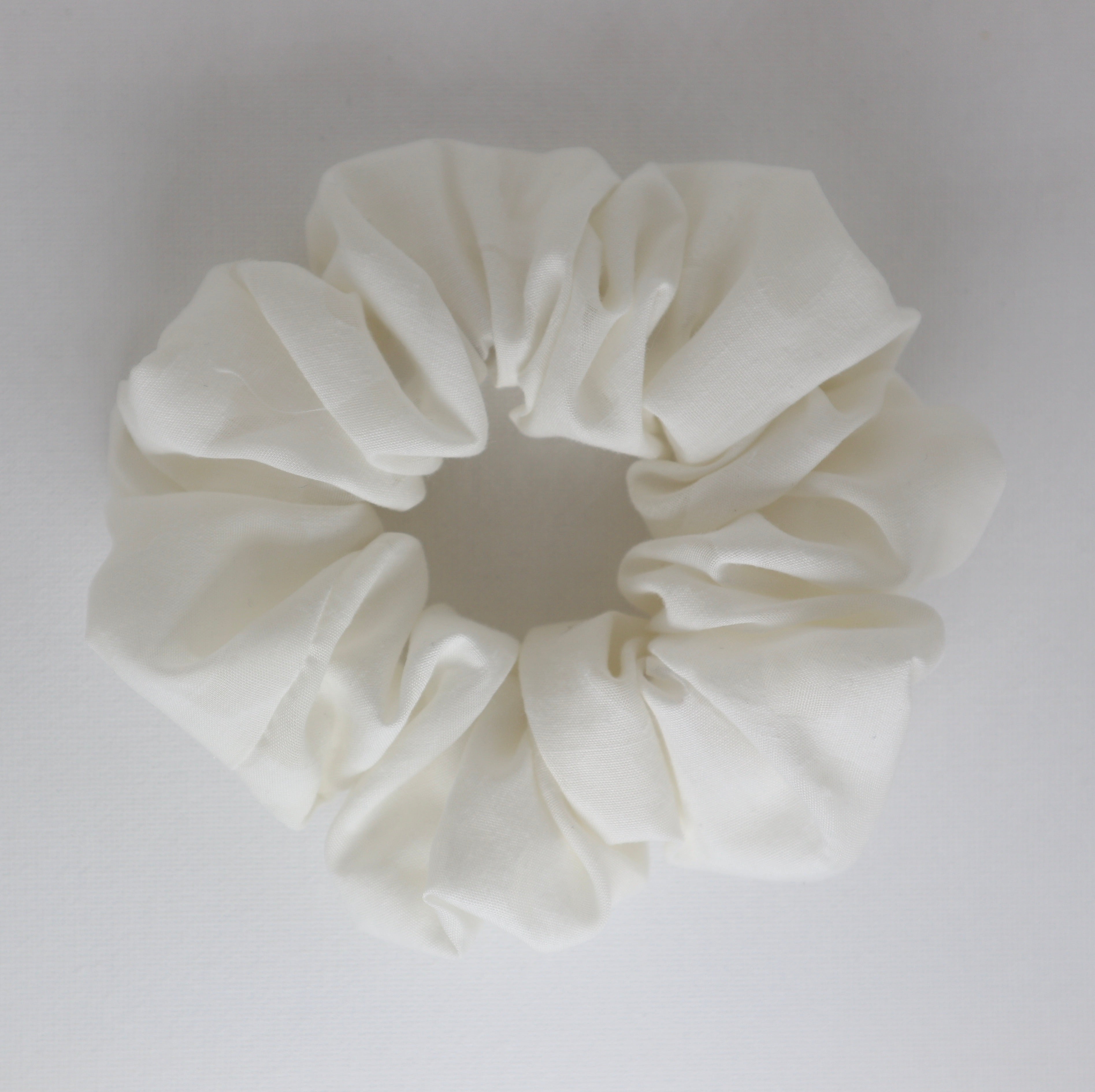 Ivory scrunchie on a light gray background