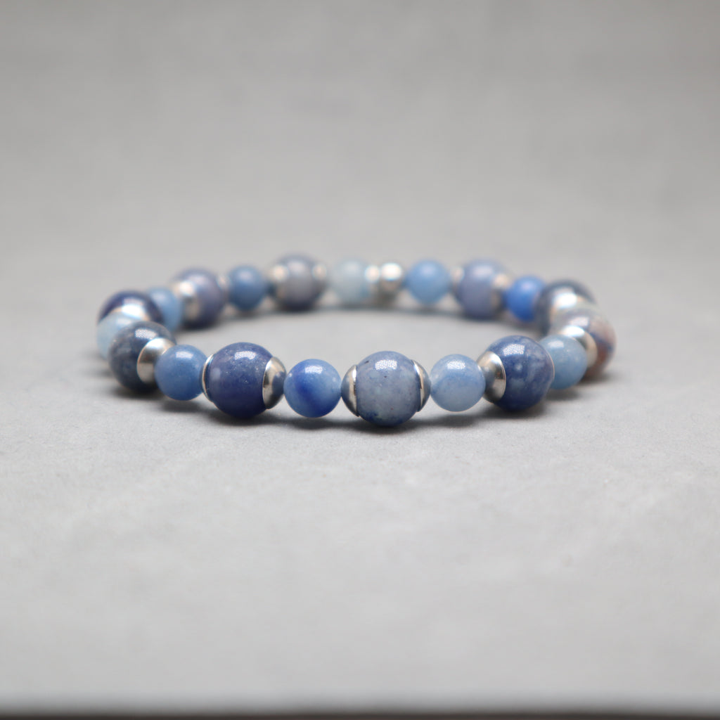 Blue beaded bracelet with silver accents on a gray background, aventurine, stainless steel
