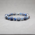 Blue beaded bracelet with silver accents on a gray background, aventurine, stainless steel