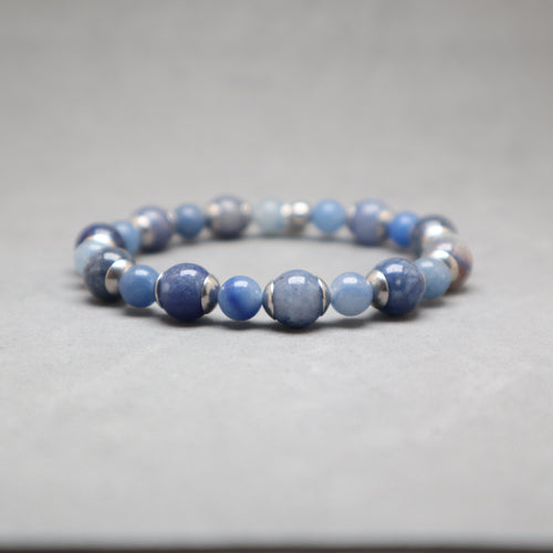 Blue beaded bracelet with silver accents on a gray background, aventurine, stainless steel