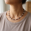 tiger eye, brown hematite, green angelite, amber glass.  Necklace wearing y a women.