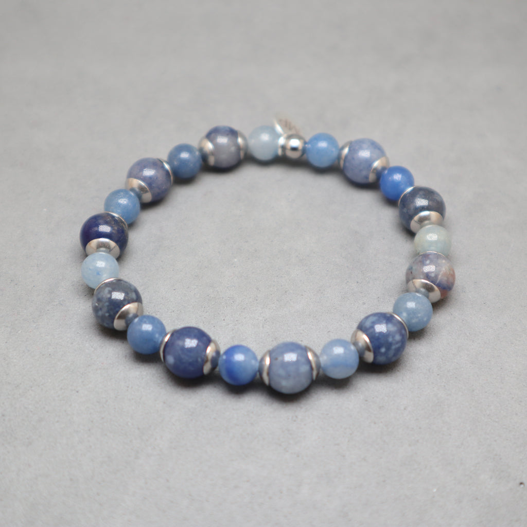 Blue beaded bracelet on a gray background