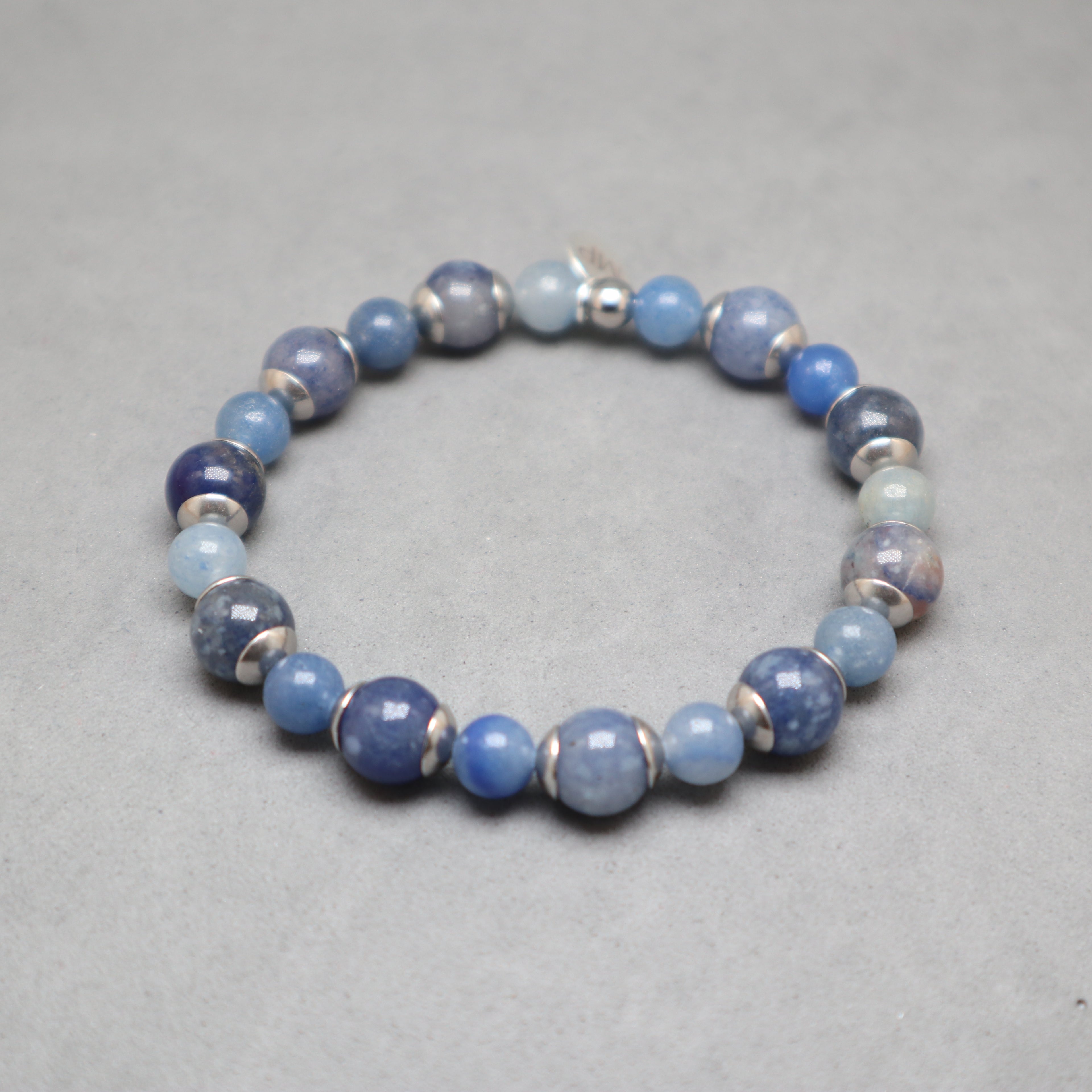Blue beaded bracelet on a gray background
