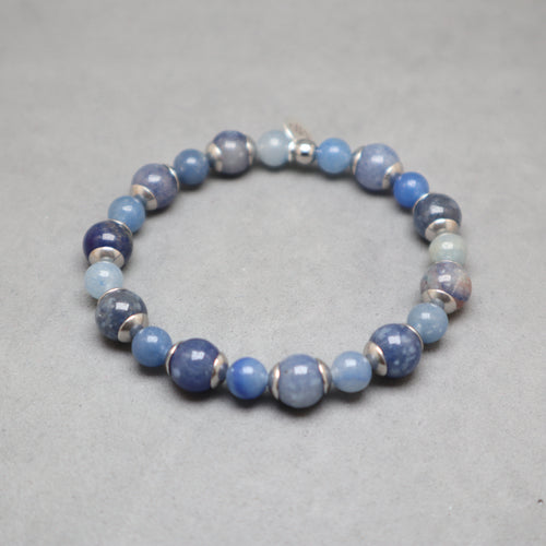 Blue beaded bracelet on a gray background