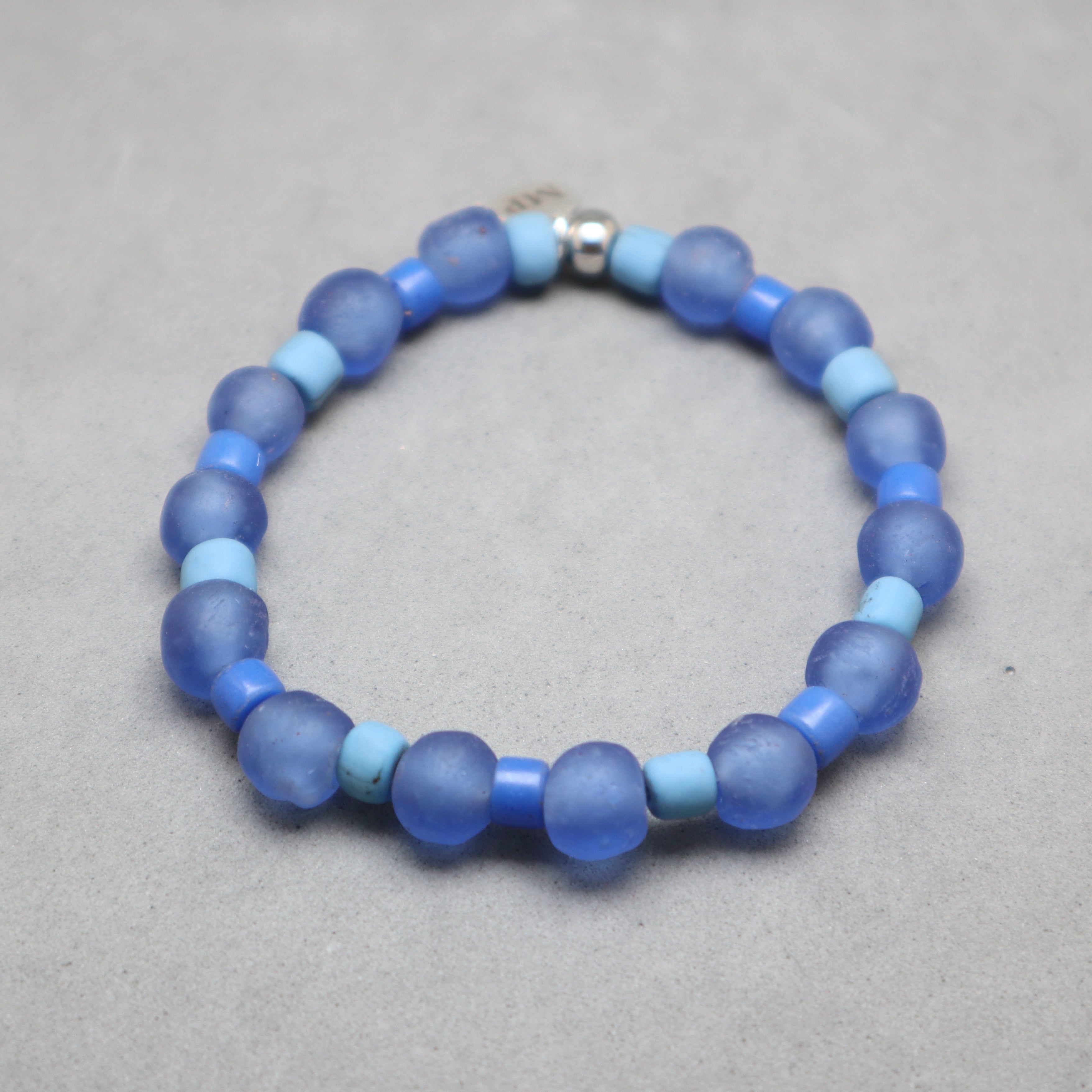 Blue beaded bracelet on a gray background,blue glass recycled