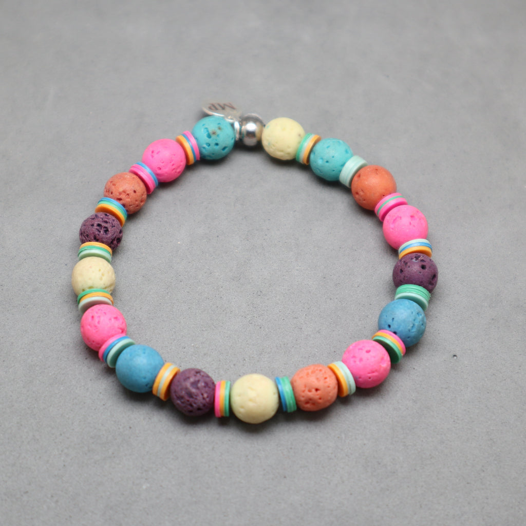 Colorful beaded bracelet on a gray background