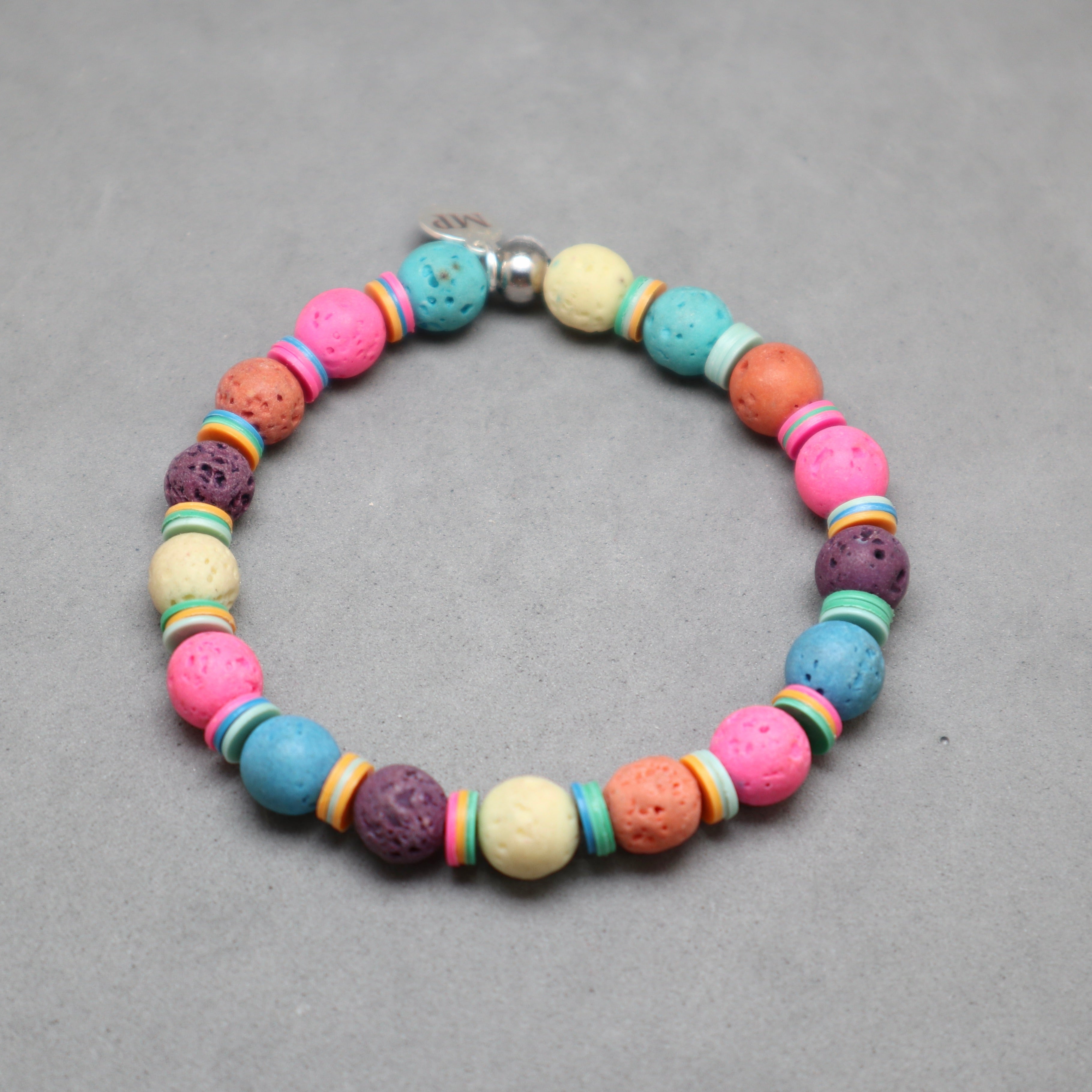 Colorful beaded bracelet on a gray background