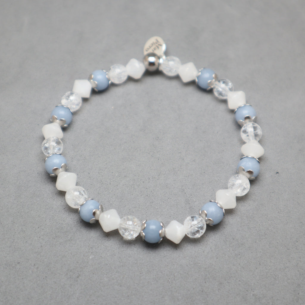 Beaded bracelet with blue and white beads on a gray background
