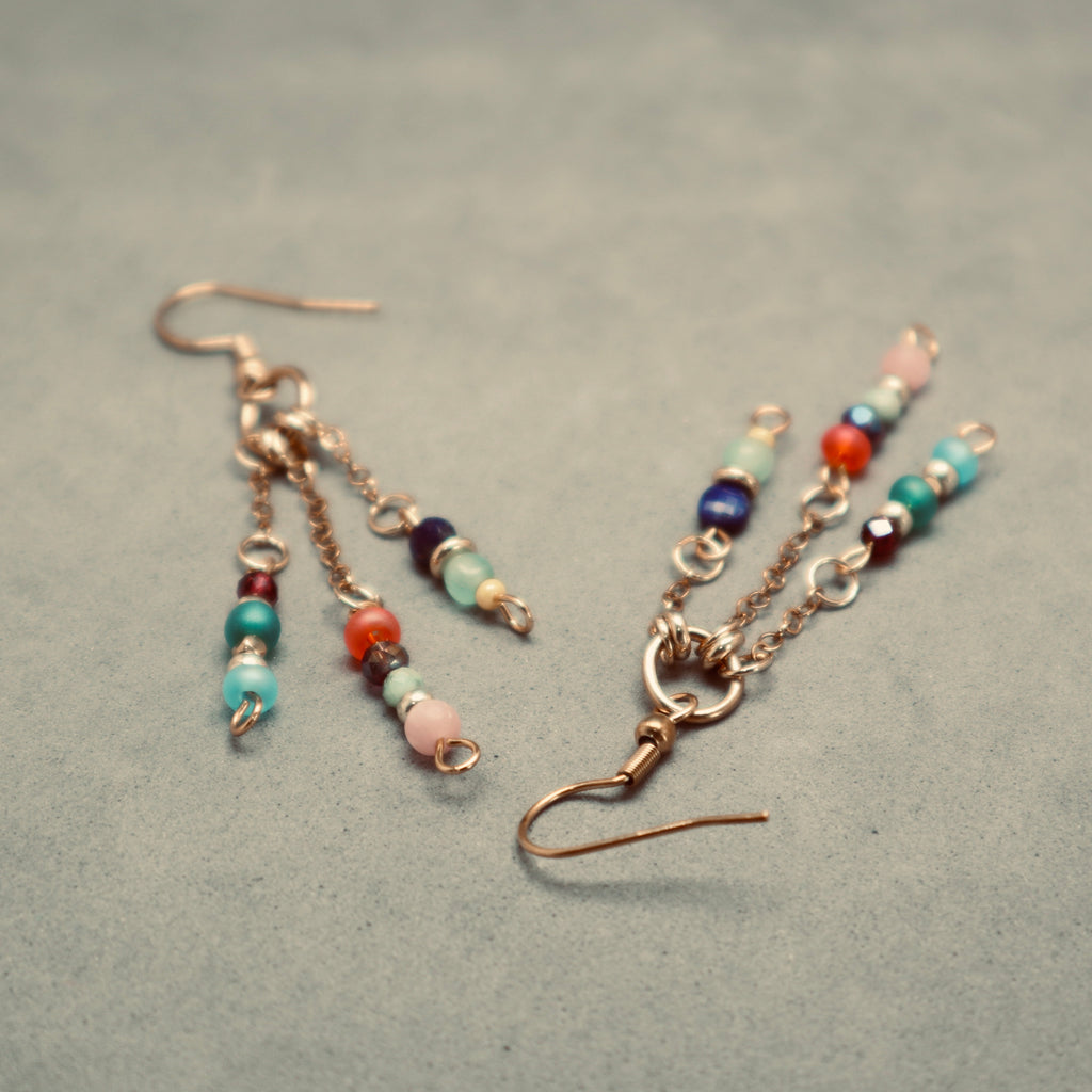 Beaded earrings on a textured gray surface