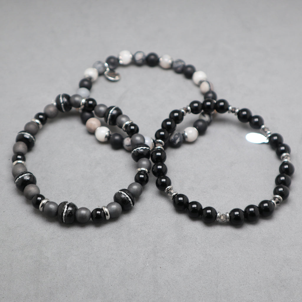 Beaded bracelets sets black and gray on a gray surface