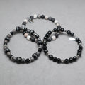 Beaded bracelets sets black and gray on a gray surface