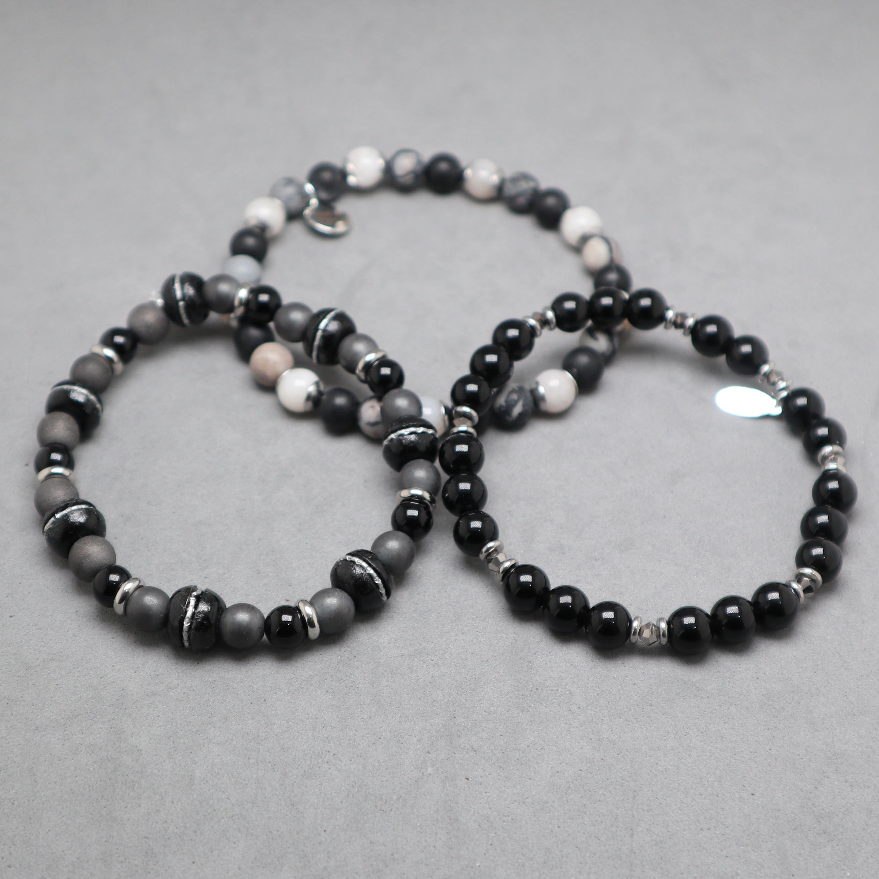 Beaded bracelets sets black and gray on a gray surface