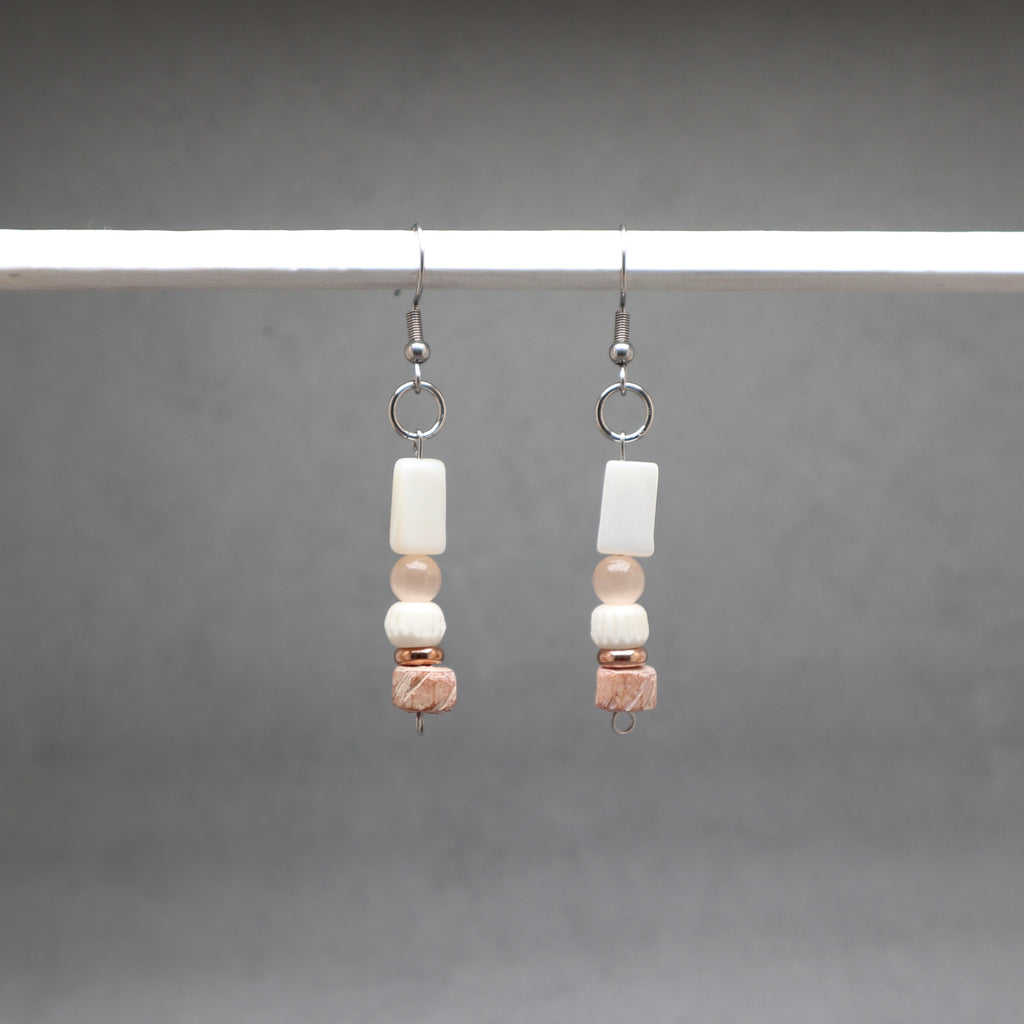 Pair of beaded earrings on a gray background