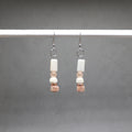 Pair of beaded earrings on a gray background