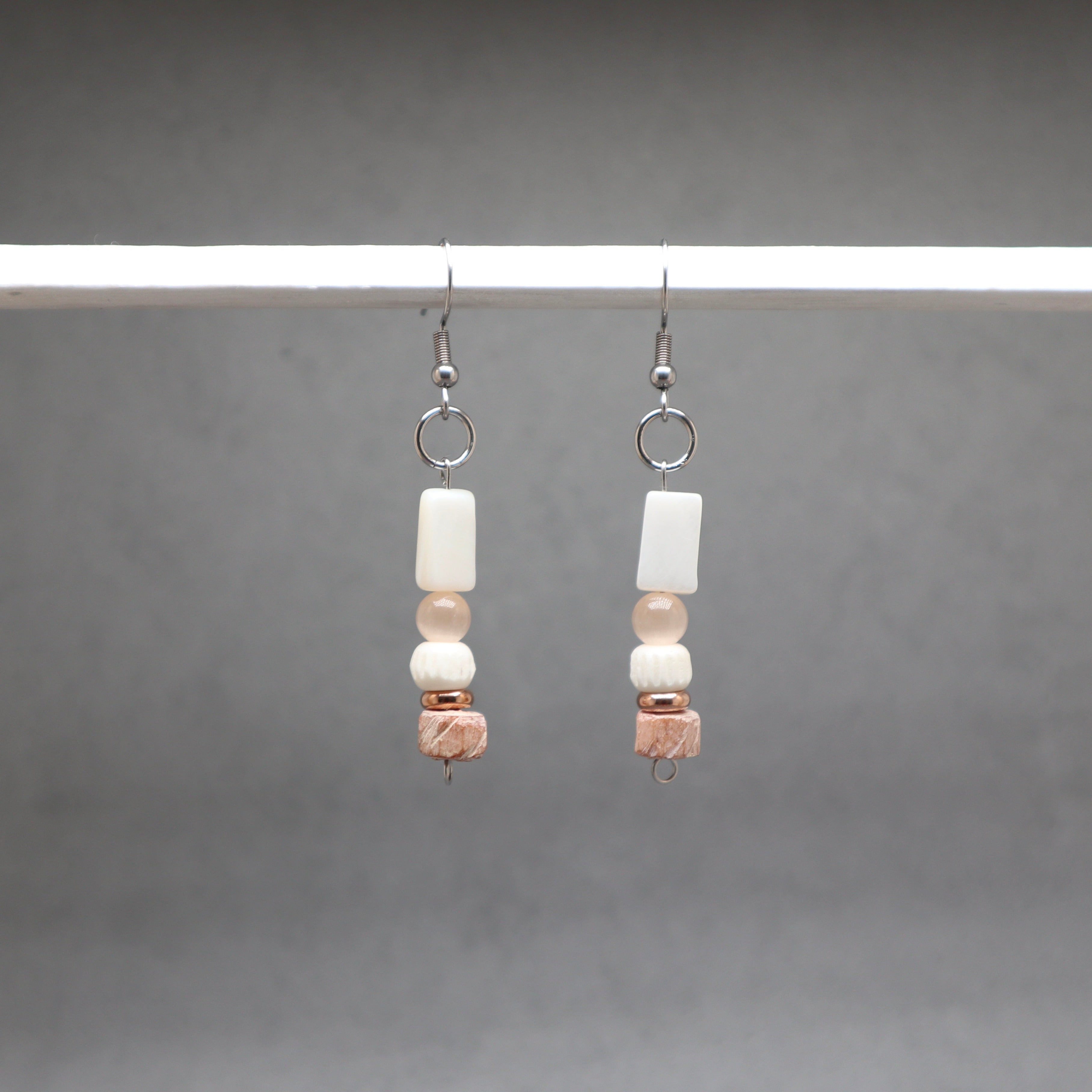 Pair of beaded earrings on a gray background