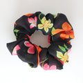 Floral-patterned scrunchie black with flowers yellow orange and pink