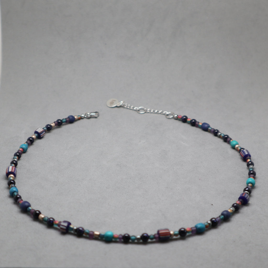 Beaded necklace on a gray background