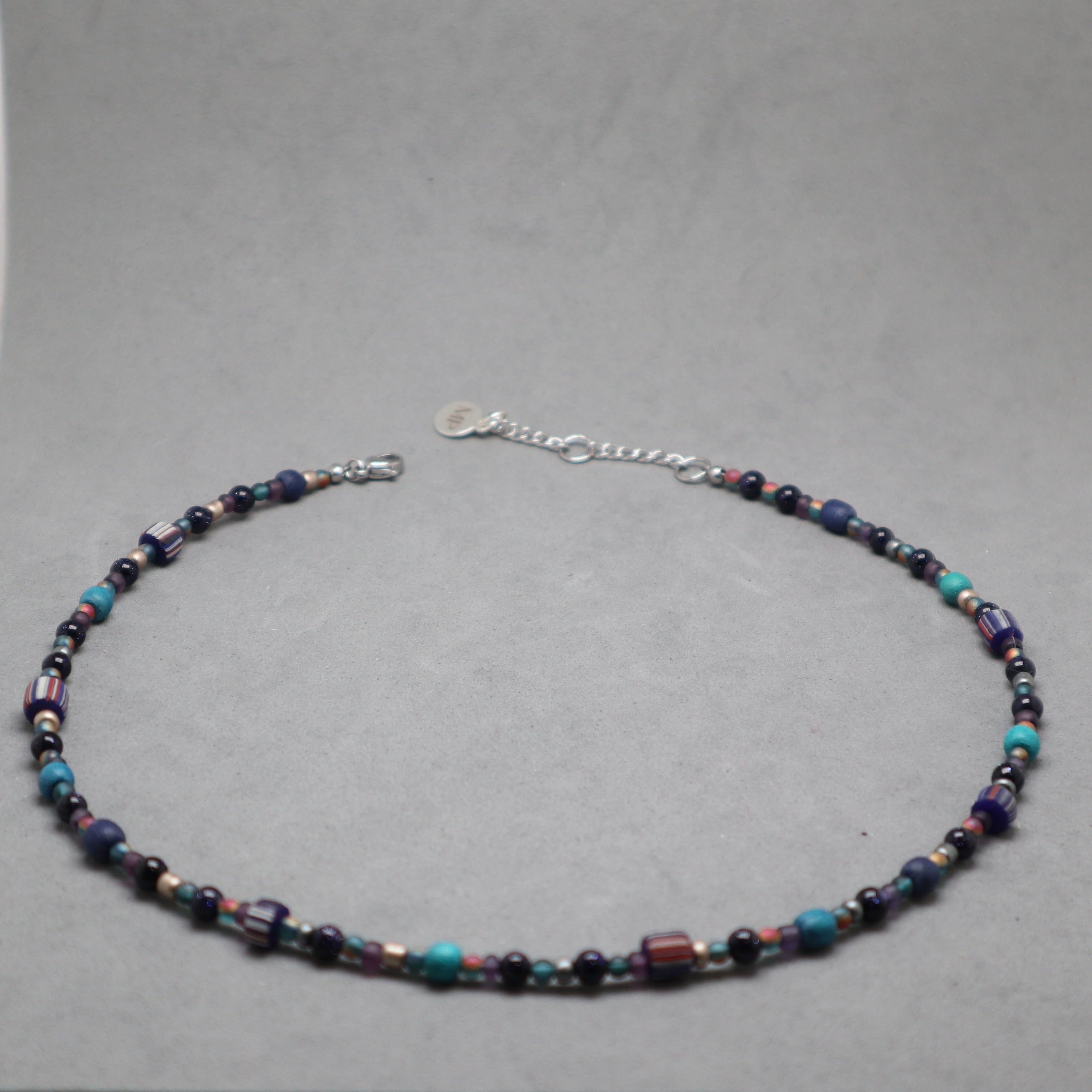 Beaded necklace on a gray background