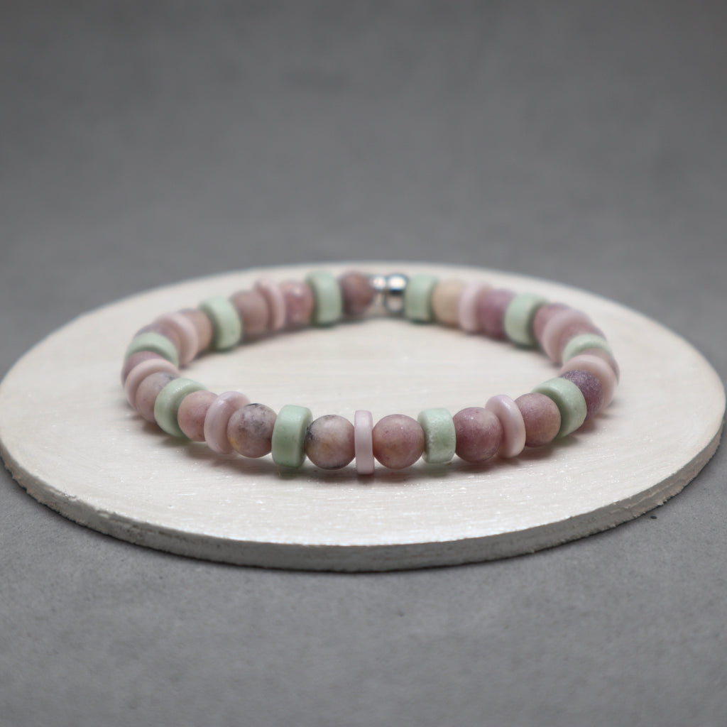 Multicolored beaded bracelet on a gray background,lepidolite, purple bone, mint bone heishi