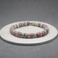 Multicolored beaded bracelet on a gray background,lepidolite, purple bone, mint bone heishi