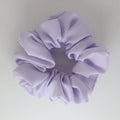 Lavender scrunchie on a light gray background