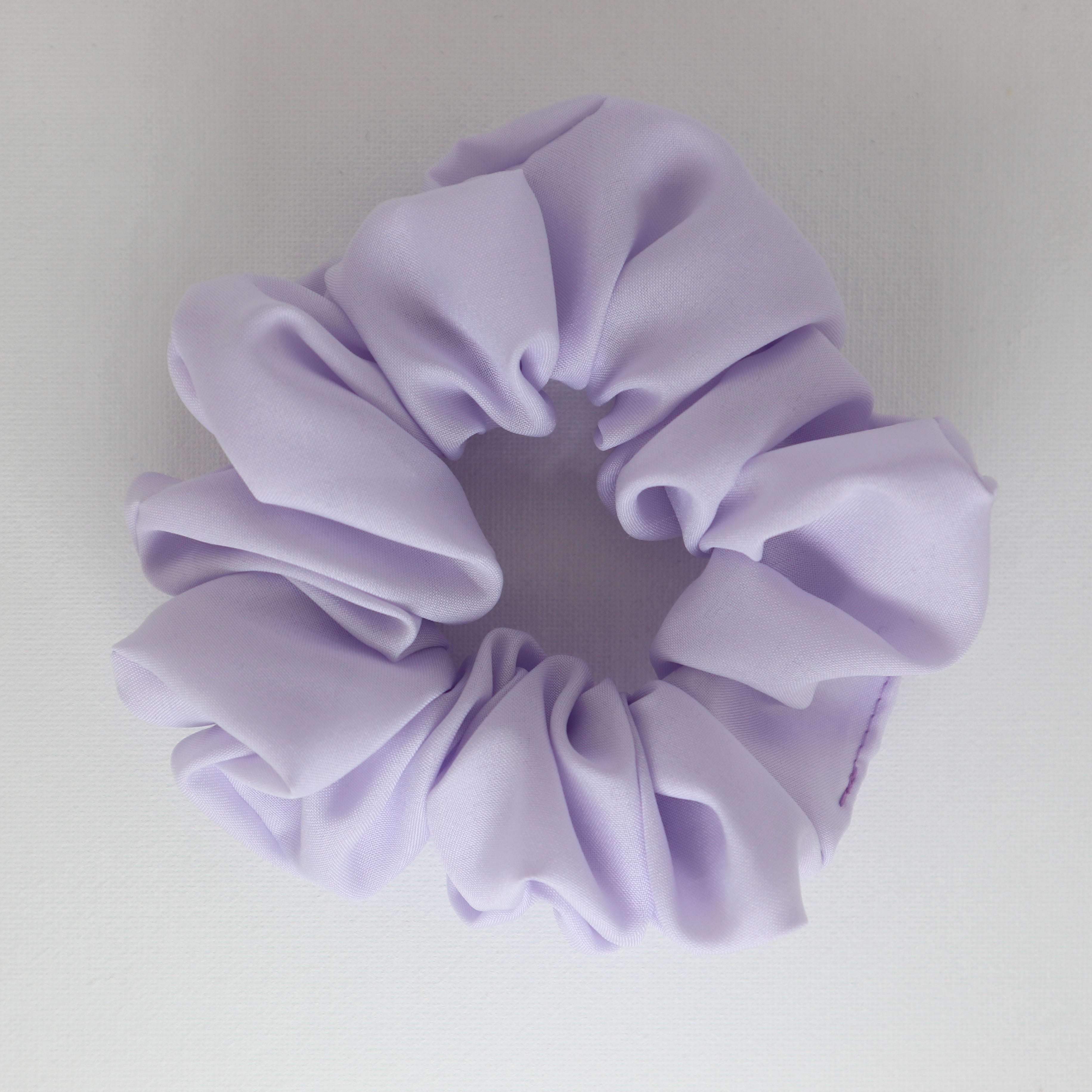 Lavender scrunchie on a light gray background