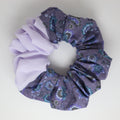 Two colors purple floral scrunchies on a light gray background
