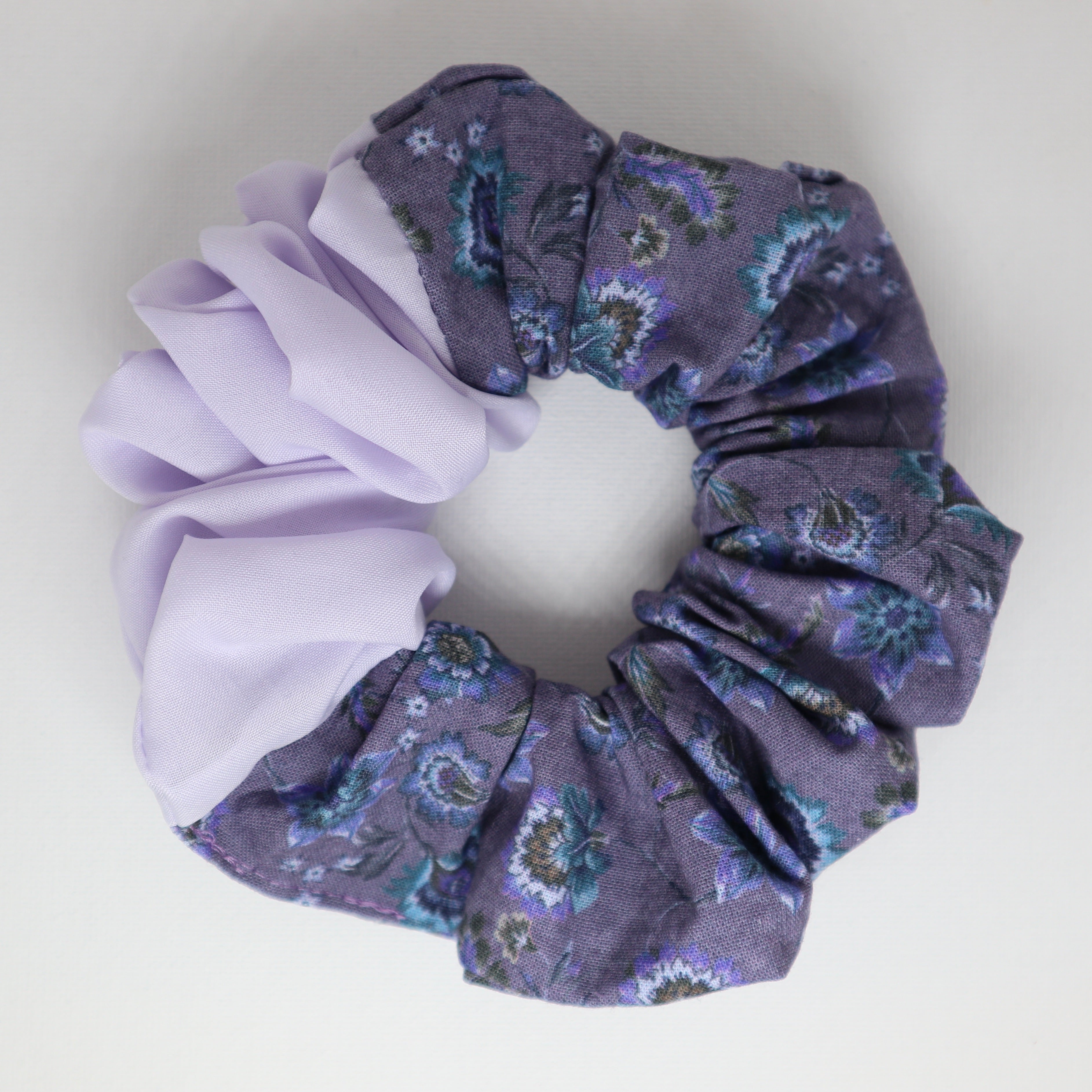 Two colors purple floral scrunchies on a light gray background