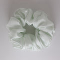 Light green scrunchie on a white background