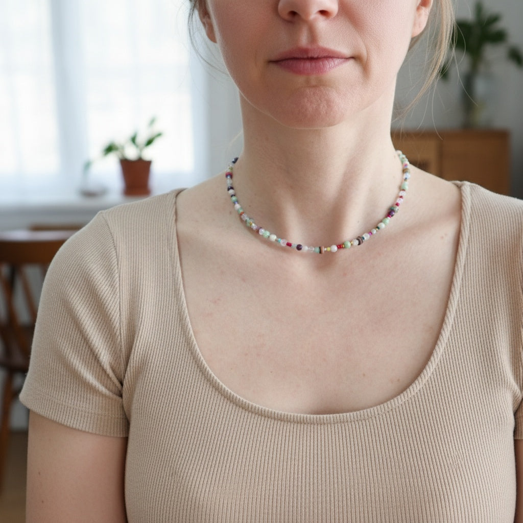 Person wearing a colorful beaded necklace indoors