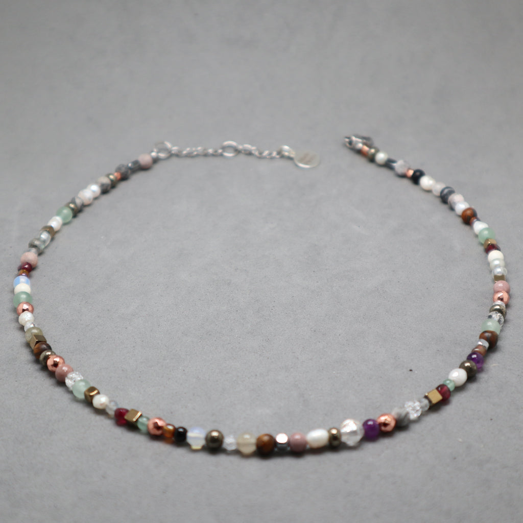 Multicolored beaded necklace on a gray background