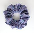 Floral purple patterned scrunchie on a white background