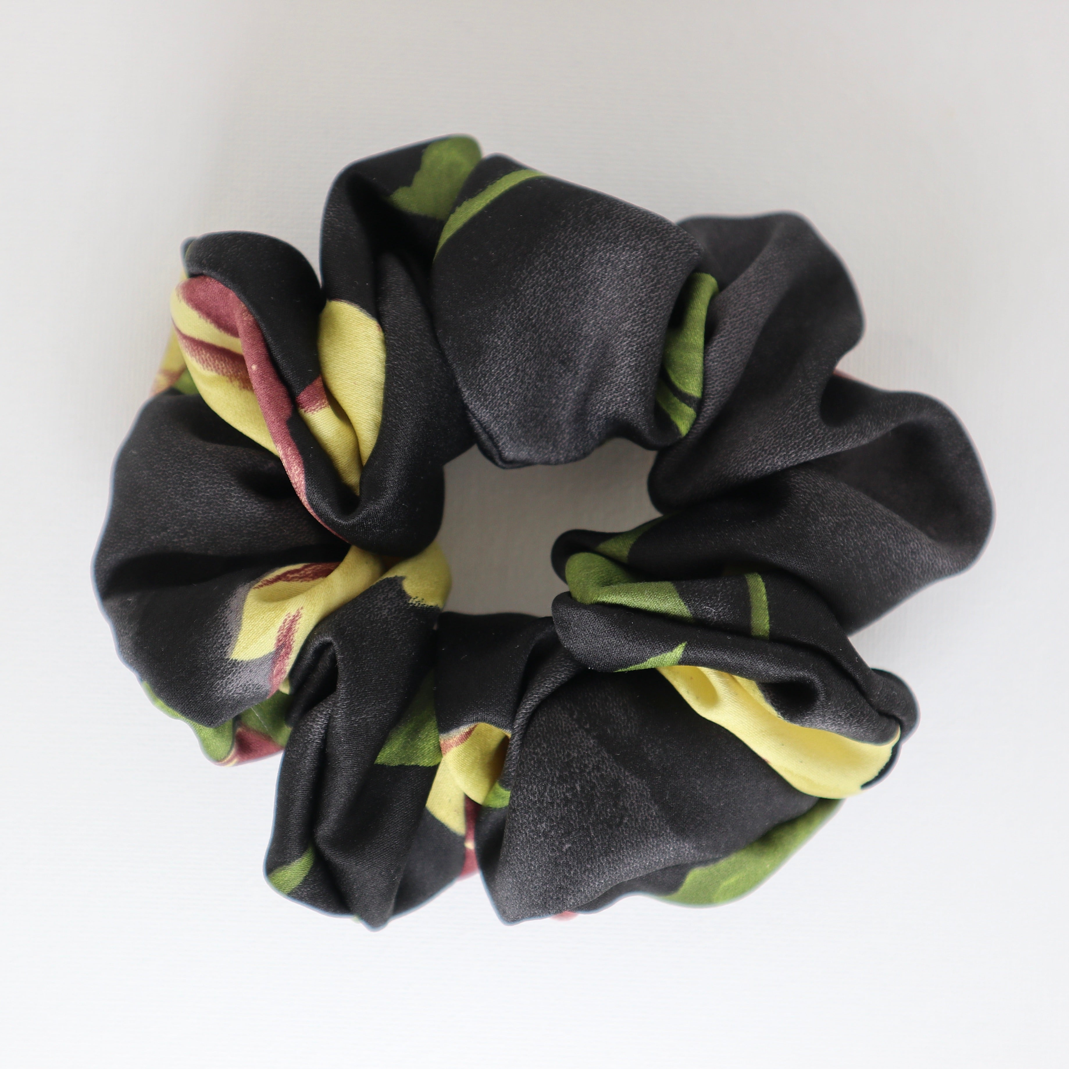 Black scrunchie with floral pattern on a white background